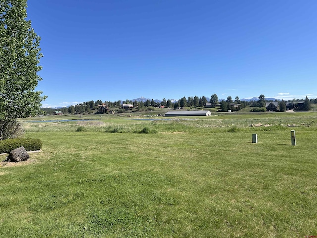 view of yard featuring a rural view and a water view