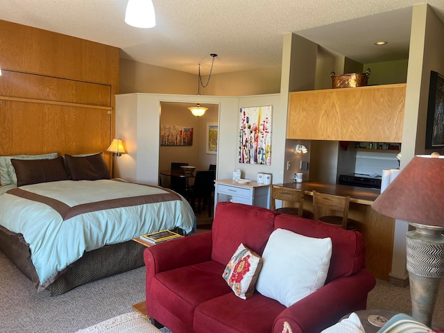 bedroom with carpet floors and a textured ceiling