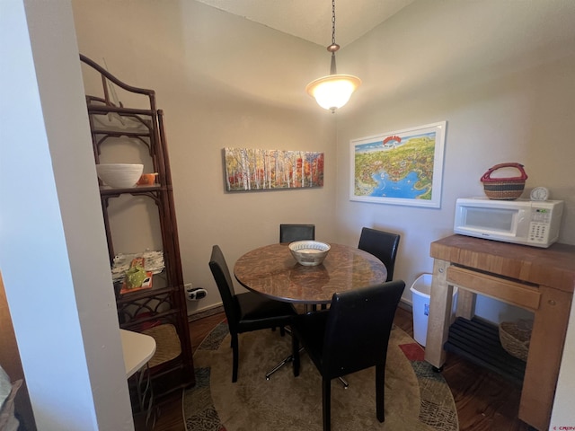 dining area featuring wood finished floors and baseboards