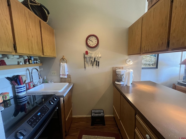 laundry room with laundry area, baseboards, and a sink