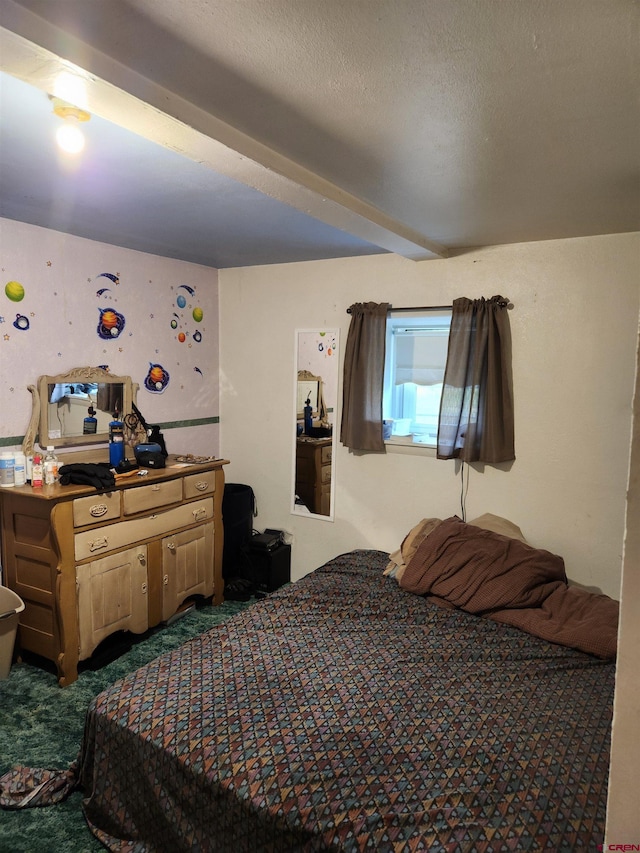 bedroom featuring a textured ceiling and carpet