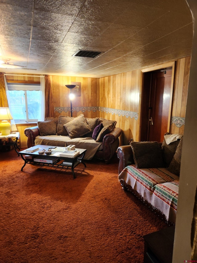 carpeted living room featuring wooden walls