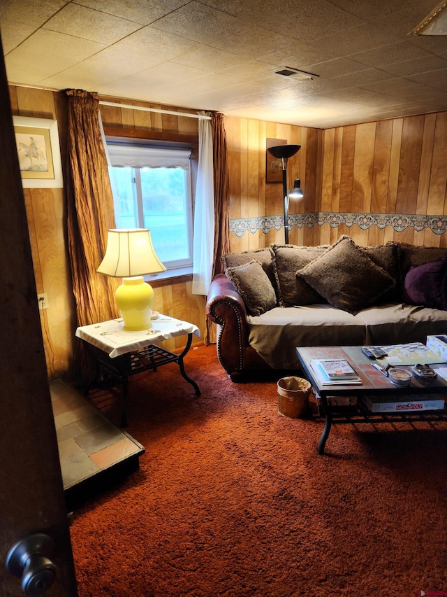 living room featuring wood walls and carpet floors