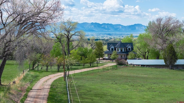 view of community featuring a lawn and a mountain view