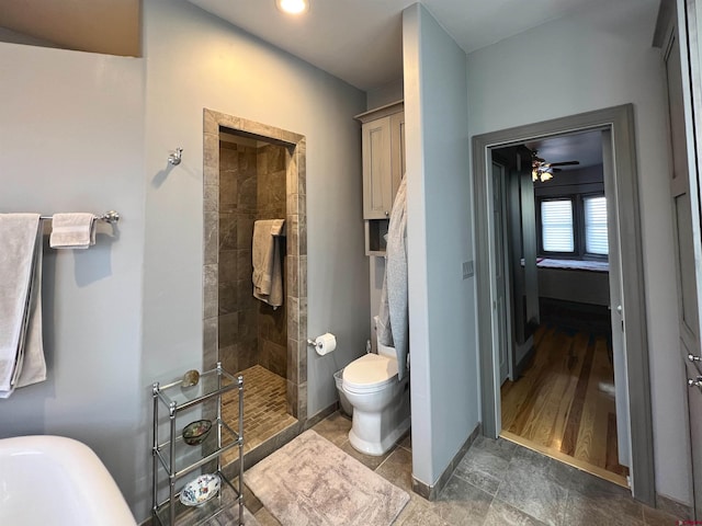 bathroom featuring tiled shower, hardwood / wood-style floors, toilet, and ceiling fan