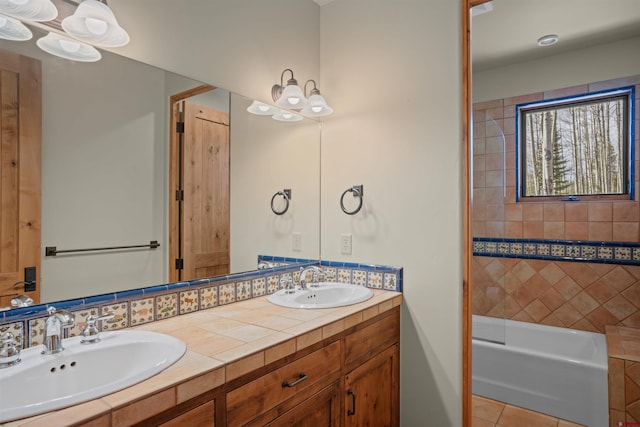 bathroom with backsplash, tile patterned floors, vanity, and tiled shower / bath