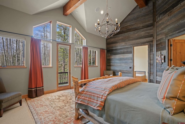 carpeted bedroom with beam ceiling, an inviting chandelier, high vaulted ceiling, wood walls, and access to outside