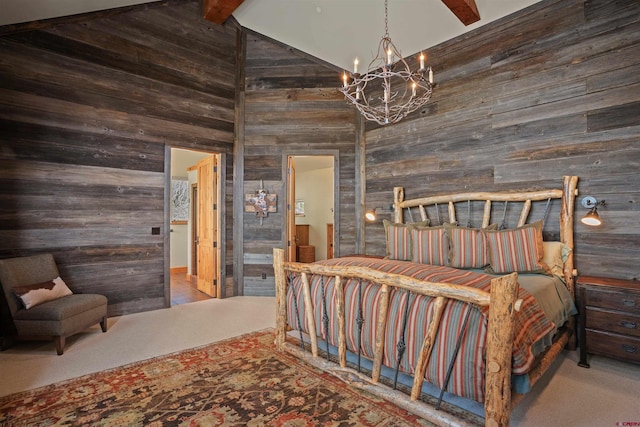 bedroom with beam ceiling, ensuite bath, high vaulted ceiling, a notable chandelier, and wooden walls