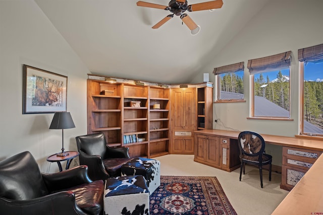 office featuring built in desk, light colored carpet, high vaulted ceiling, and ceiling fan