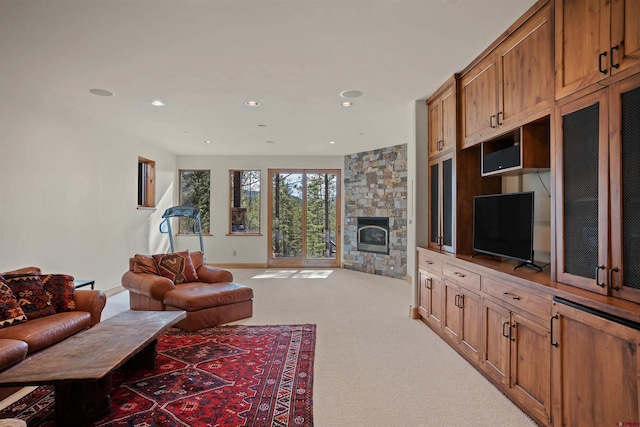 living room featuring carpet and a fireplace