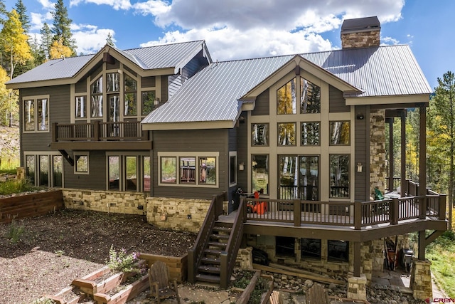 rear view of property featuring a wooden deck