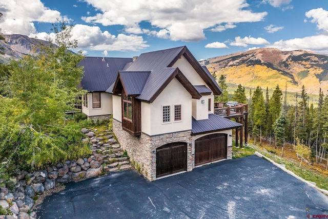 view of front facade featuring a mountain view and a garage