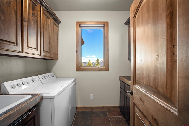 laundry area with washing machine and clothes dryer and cabinets