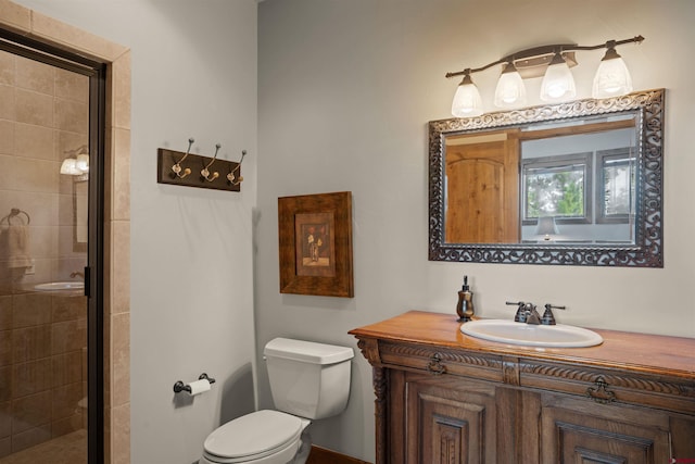 bathroom with vanity, toilet, and a shower with shower door