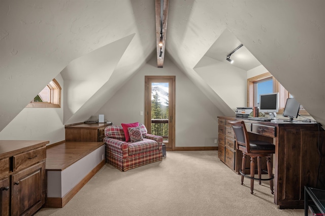 home office with lofted ceiling, rail lighting, and light carpet