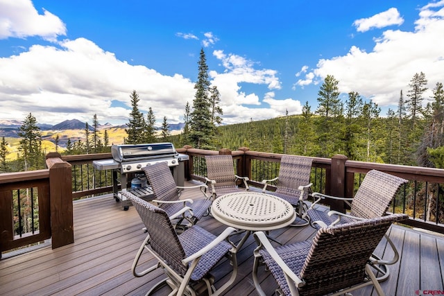 wooden terrace featuring grilling area and a mountain view