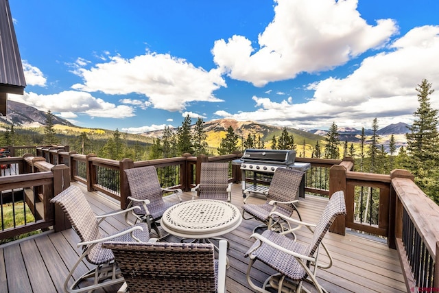 wooden deck featuring grilling area and a mountain view