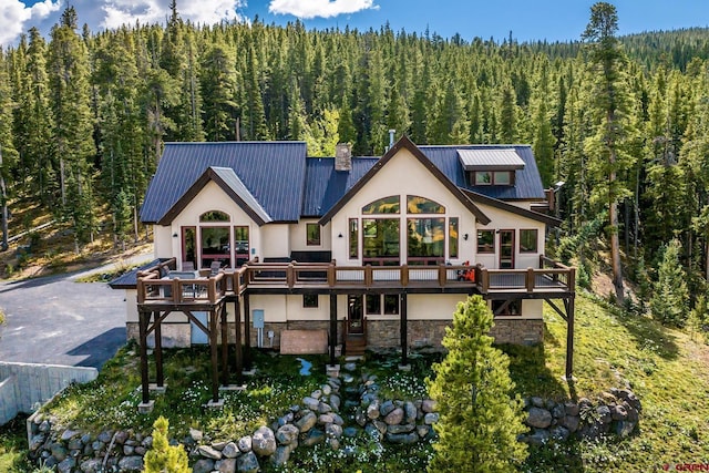 rear view of property featuring a wooden deck