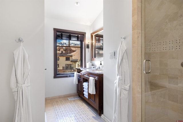 bathroom featuring vanity, tile patterned floors, and a shower with shower door