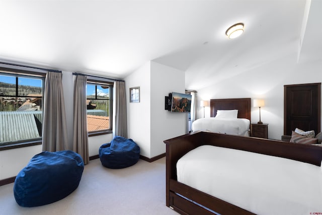 carpeted bedroom featuring lofted ceiling