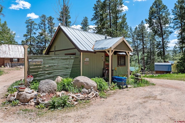 view of front of house with a storage unit