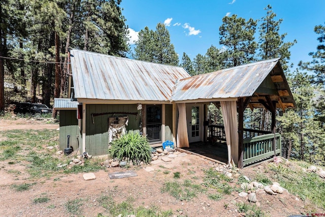 view of front of property featuring an outdoor structure and a wooden deck