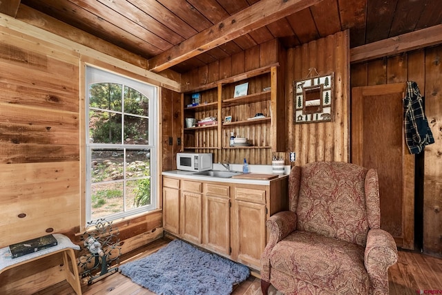 interior space featuring beamed ceiling, wood ceiling, sink, wood walls, and hardwood / wood-style flooring