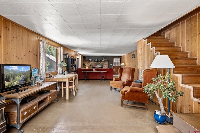 living room with wooden walls and concrete floors