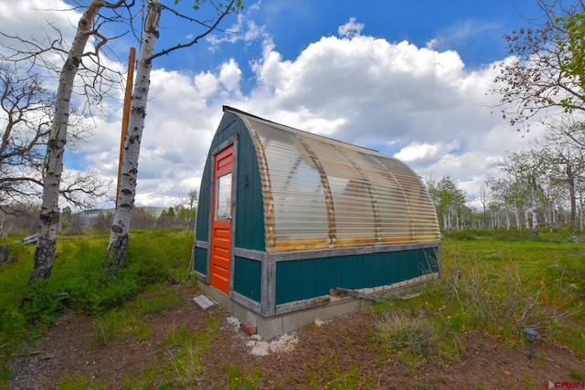 view of property exterior featuring an outdoor structure