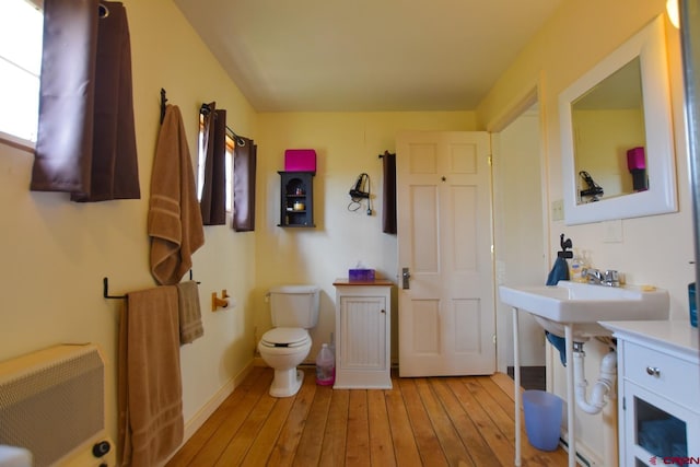 bathroom with wood-type flooring and toilet