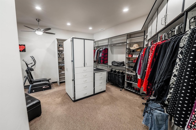 walk in closet featuring ceiling fan and light colored carpet