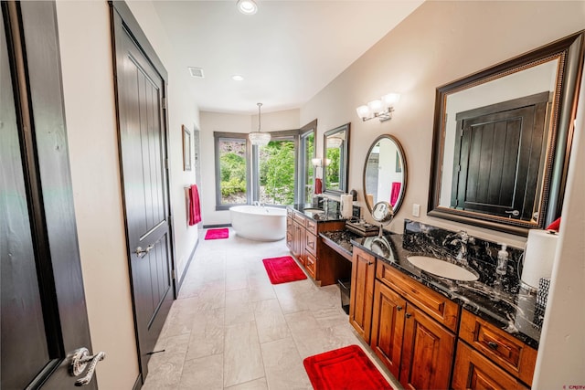 bathroom with tile floors, double sink vanity, and a bath to relax in