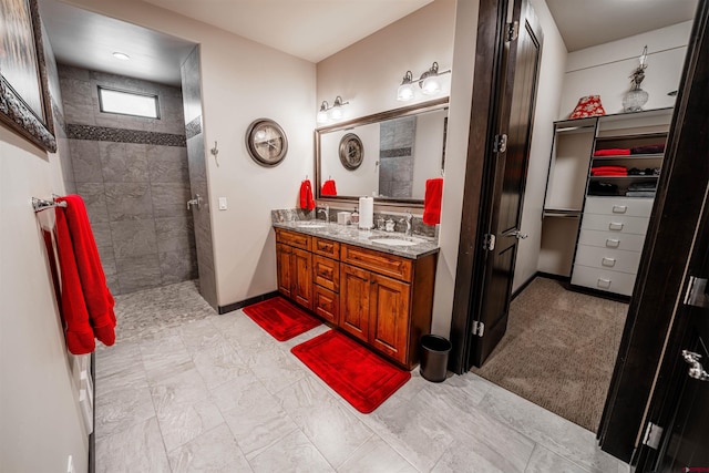 bathroom with tile floors, a tile shower, and dual bowl vanity