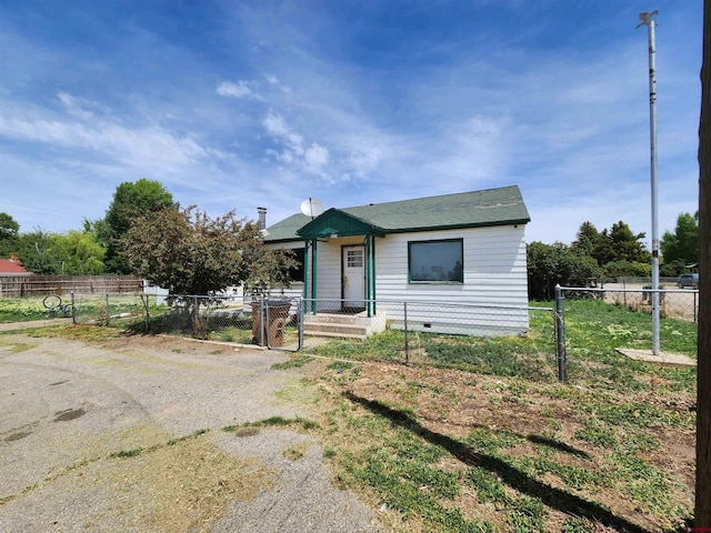bungalow-style house with crawl space, a fenced front yard, and a gate