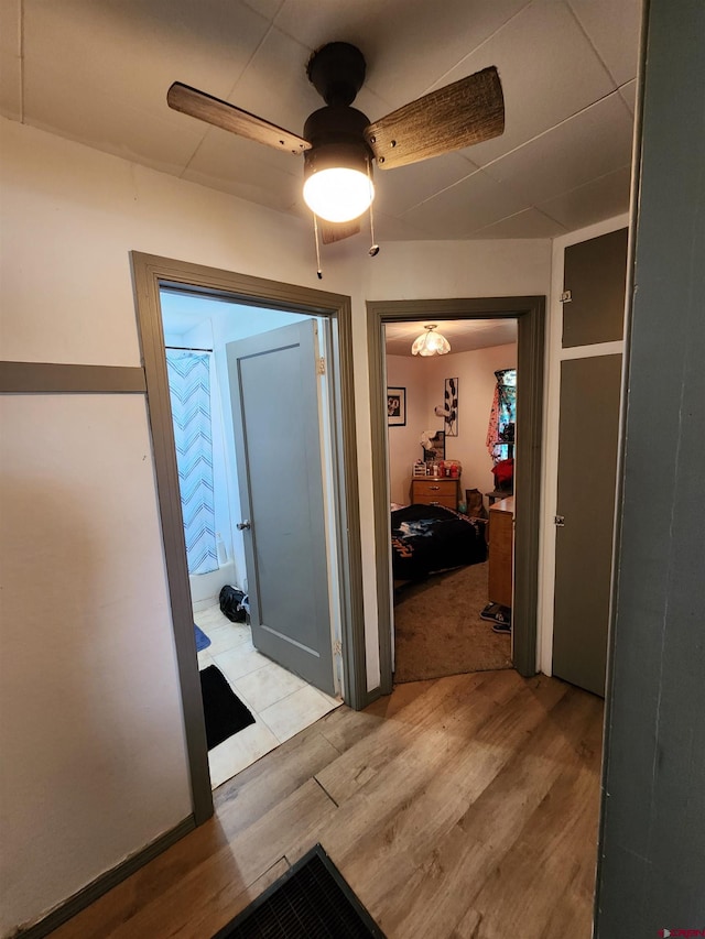 hallway with light hardwood / wood-style flooring