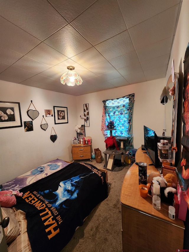 carpeted bedroom featuring a paneled ceiling