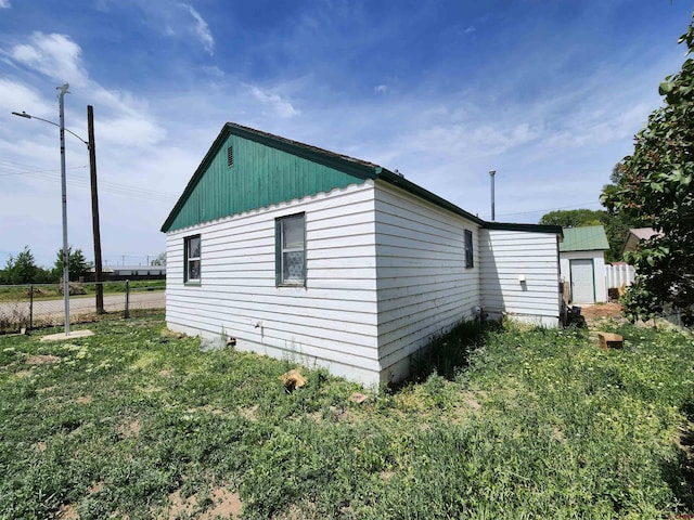 view of home's exterior with a shed