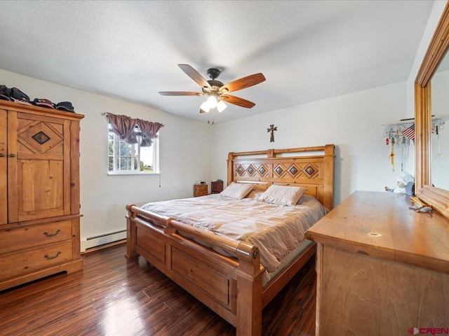 bedroom with dark wood-type flooring, baseboard heating, ceiling fan, and a textured ceiling