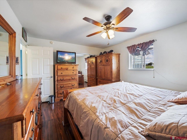 bedroom with dark hardwood / wood-style flooring and ceiling fan