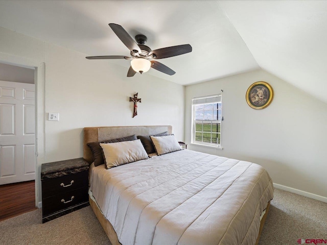 bedroom featuring ceiling fan, vaulted ceiling, and carpet flooring