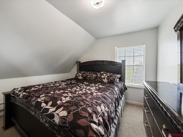 carpeted bedroom with vaulted ceiling