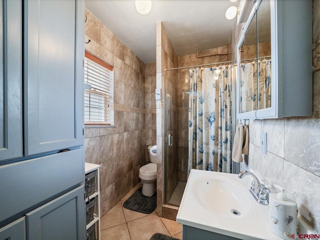 bathroom with tile walls, tile floors, vanity, and toilet