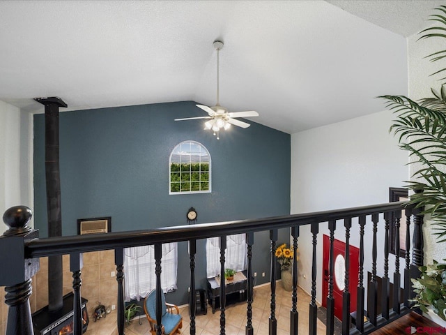 corridor with tile floors and lofted ceiling