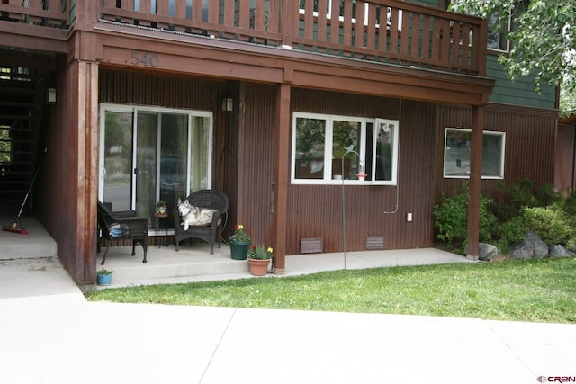 back of property featuring a patio area and a balcony