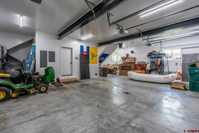 garage with a garage door opener and electric panel