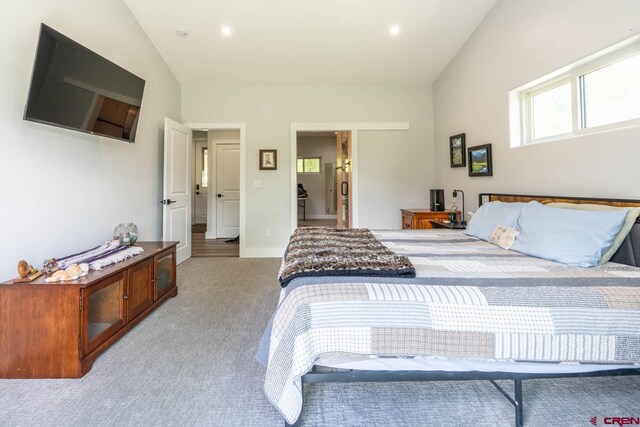 carpeted bedroom featuring lofted ceiling