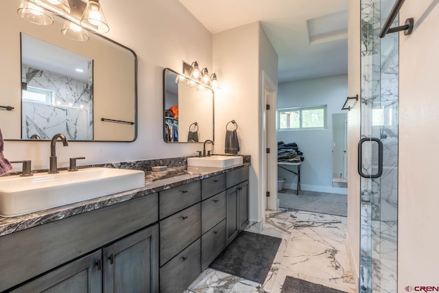 bathroom featuring a wealth of natural light, vanity, and a shower with shower door