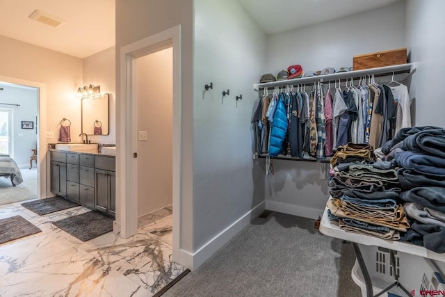 walk in closet with carpet and sink