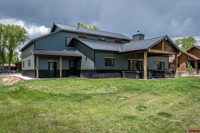 rear view of property featuring a lawn