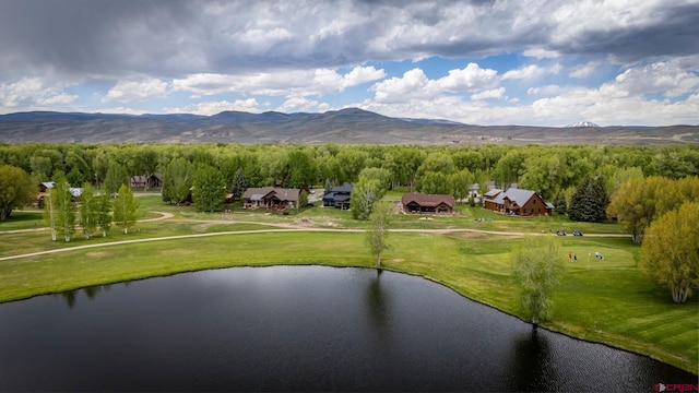 exterior space with a water and mountain view